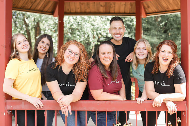 Dr. Elijah Ed and dental staff smiling